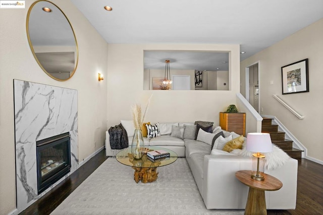 living room featuring a premium fireplace and dark hardwood / wood-style flooring