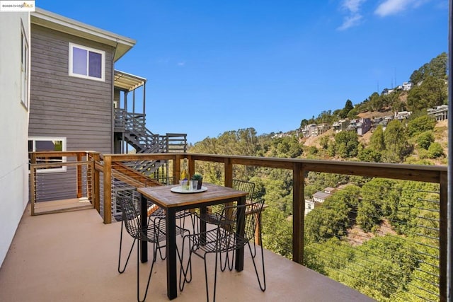 wooden balcony featuring a deck and a patio