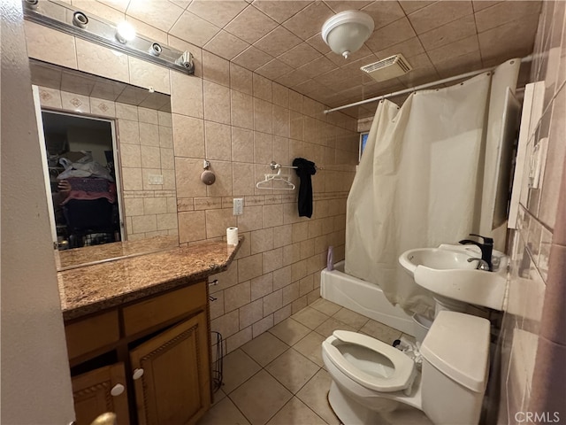 full bathroom with tile walls, toilet, tile patterned floors, and shower / bath combo