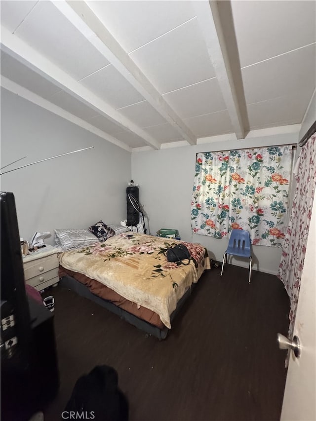 bedroom with wood-type flooring and beam ceiling