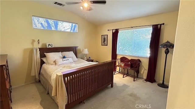 bedroom with lofted ceiling, a ceiling fan, visible vents, and light colored carpet