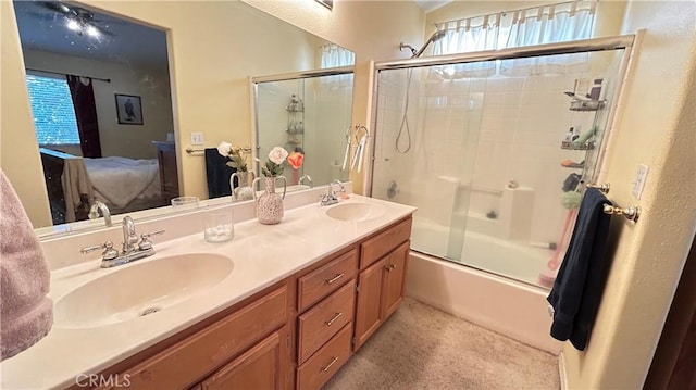 ensuite bathroom featuring shower / bath combination with glass door, a healthy amount of sunlight, a sink, and ensuite bath