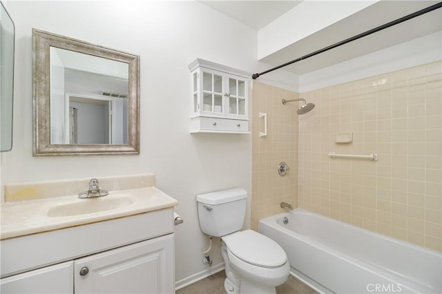 full bathroom featuring tiled shower / bath, vanity, and toilet