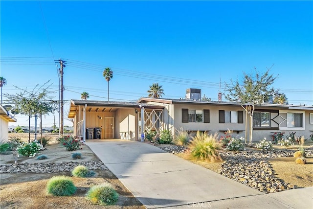 view of front of home featuring a carport and central AC unit