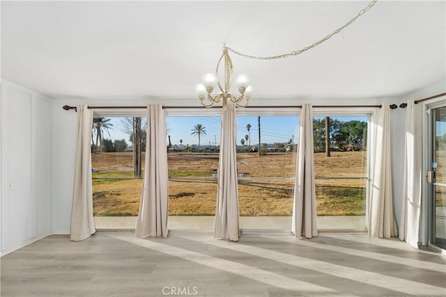 entryway with a notable chandelier and light wood-type flooring