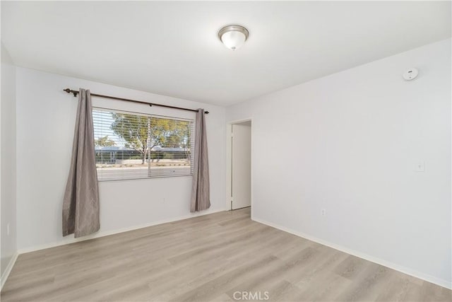 spare room featuring light hardwood / wood-style flooring