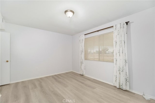 unfurnished room with light hardwood / wood-style floors