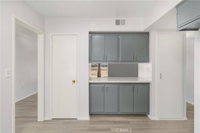 kitchen featuring light hardwood / wood-style floors and gray cabinetry