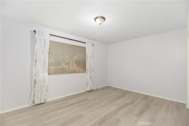 unfurnished room with light hardwood / wood-style flooring