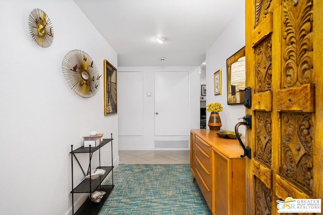 hall with dark tile patterned flooring