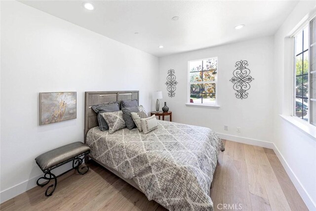 bedroom featuring baseboards, recessed lighting, and light wood-style floors