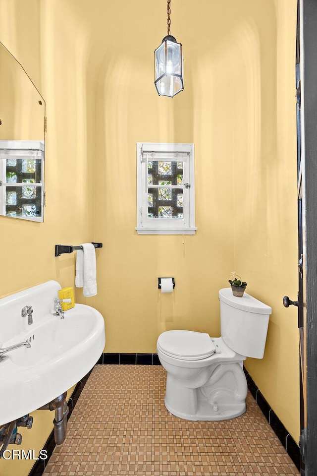 bathroom featuring toilet and tile patterned flooring