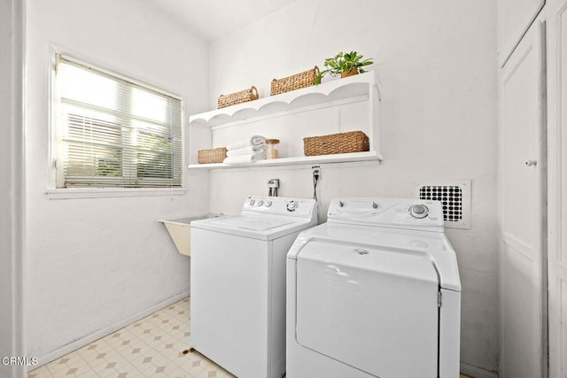 clothes washing area featuring washer and dryer and sink