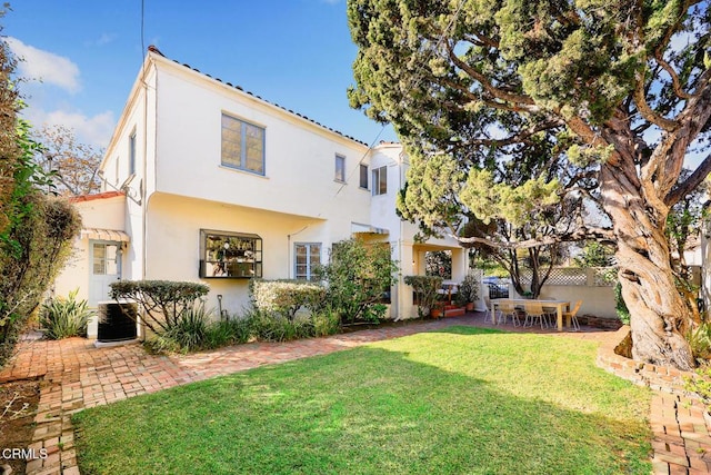 exterior space with a yard, central AC, and a patio area