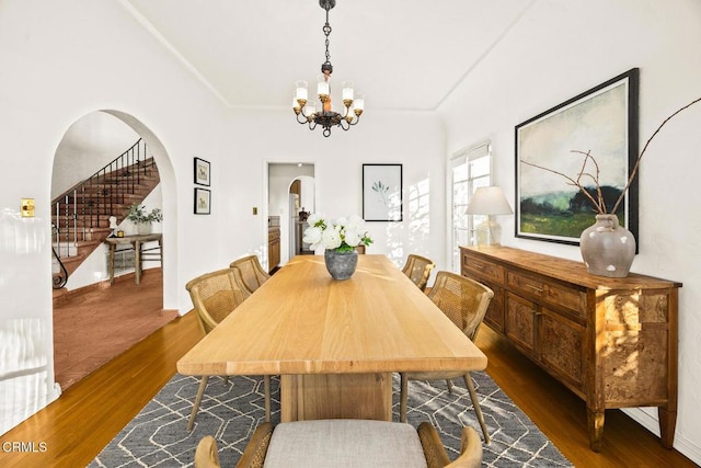 dining room featuring a chandelier and dark wood-type flooring