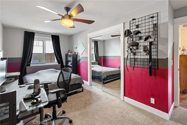 carpeted bedroom featuring ceiling fan and a closet