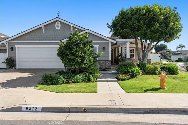 view of front of home featuring a front lawn and a garage