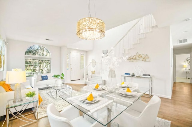 dining area with an inviting chandelier and wood-type flooring