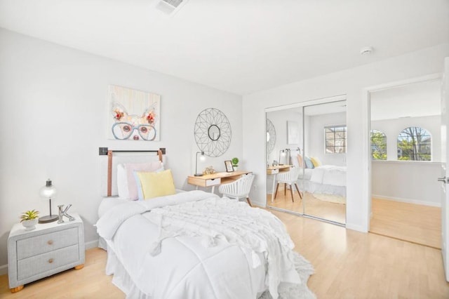 bedroom featuring light hardwood / wood-style flooring and a closet