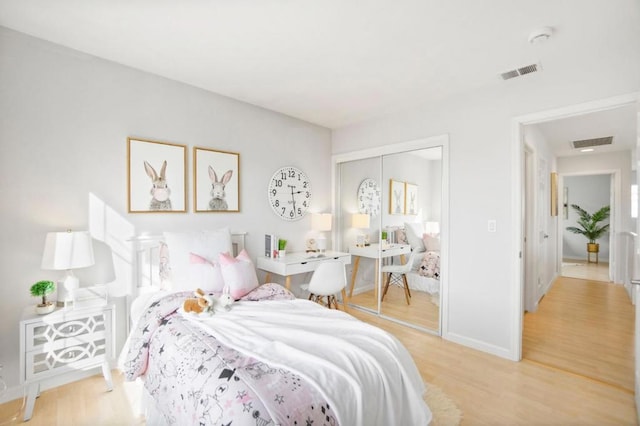 bedroom with light wood-type flooring and a closet