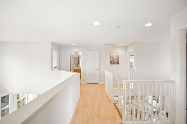 hall featuring light wood-type flooring and plenty of natural light