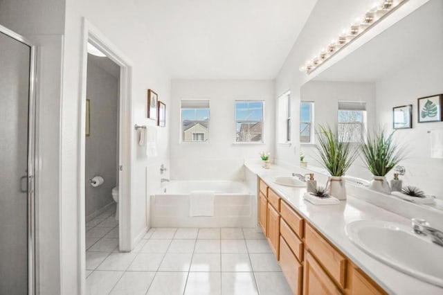 full bathroom featuring toilet, shower with separate bathtub, vanity, and tile patterned floors