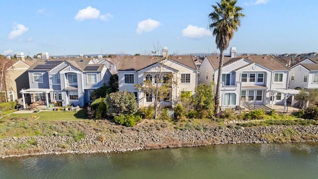 rear view of house with a water view