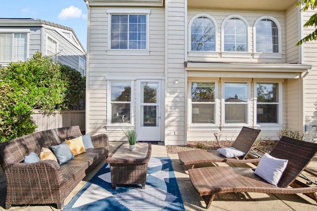 rear view of house with a patio area and an outdoor living space