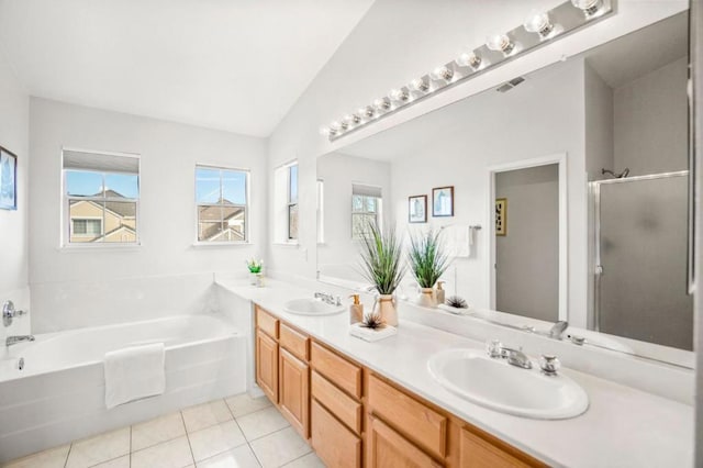 bathroom with vanity, vaulted ceiling, tile patterned floors, and shower with separate bathtub