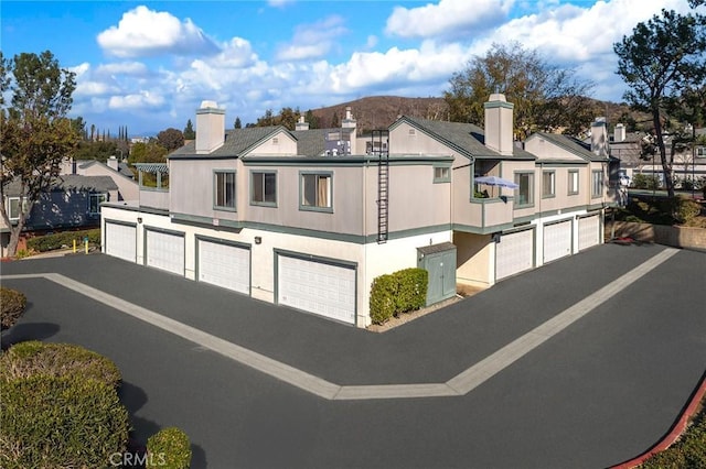 exterior space with a garage and a mountain view