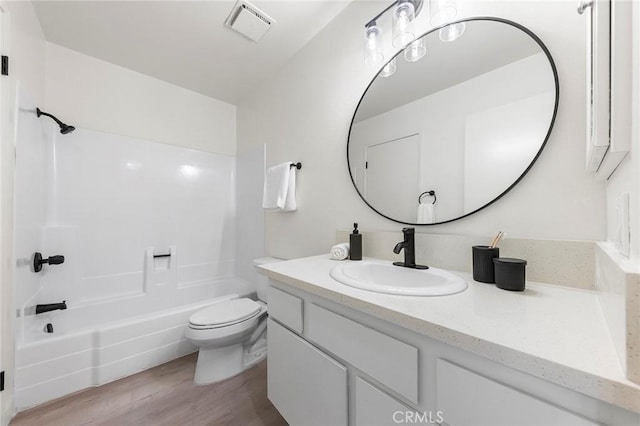 full bathroom featuring vanity, shower / washtub combination, toilet, and hardwood / wood-style floors