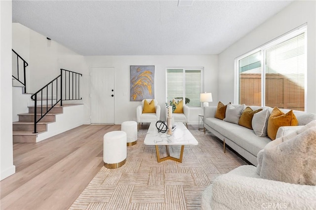 living room featuring a textured ceiling and light hardwood / wood-style floors