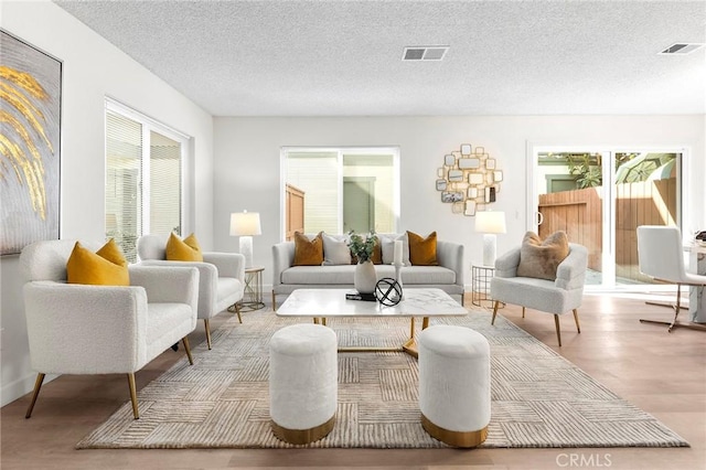 sitting room featuring a textured ceiling and light wood-type flooring