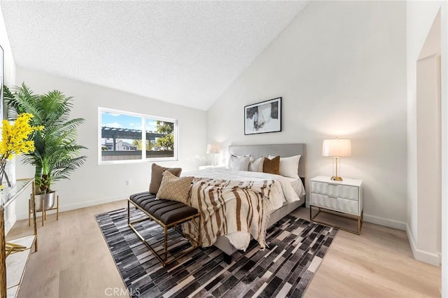 bedroom with lofted ceiling and light wood-type flooring