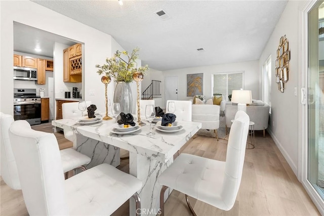 dining space featuring light hardwood / wood-style floors