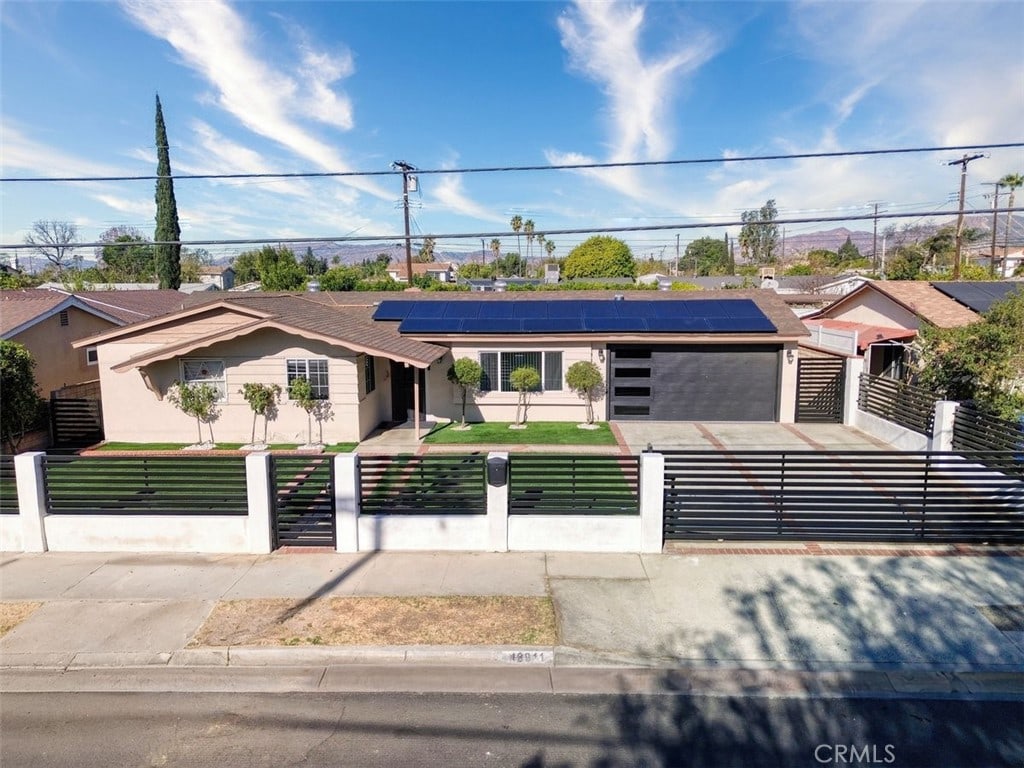 single story home with solar panels