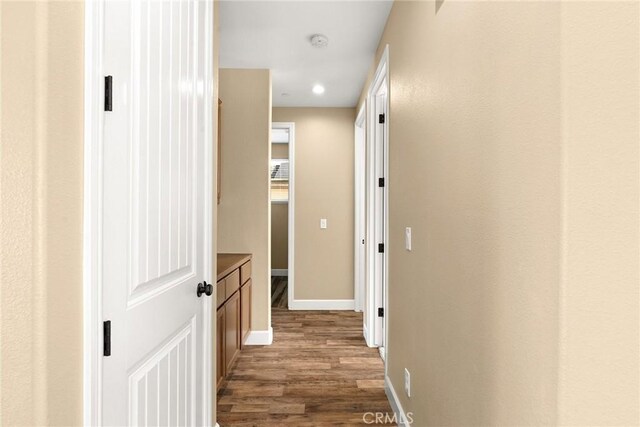 hall with dark wood-type flooring