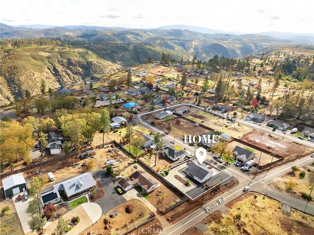 birds eye view of property with a mountain view