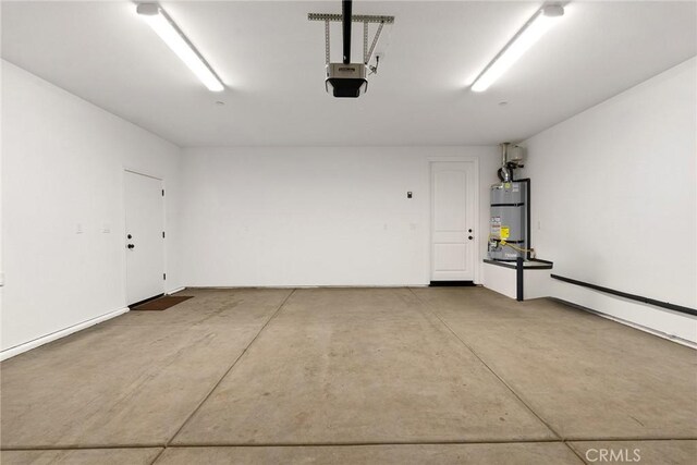 garage with water heater and a garage door opener