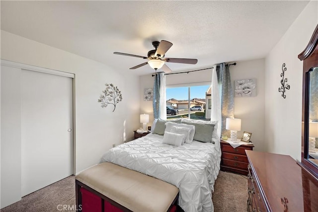 bedroom featuring ceiling fan, a closet, and carpet floors