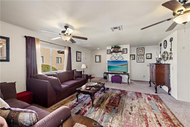 living room with ceiling fan and light colored carpet