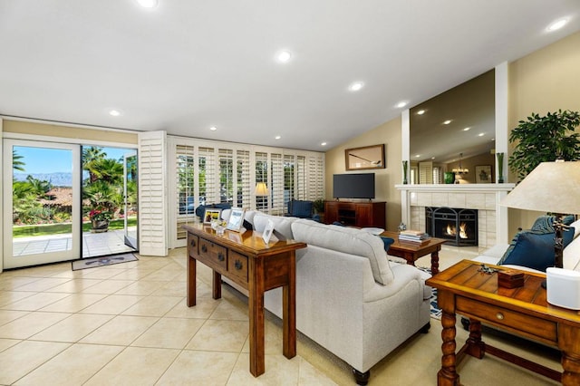 tiled living room with lofted ceiling and a tiled fireplace