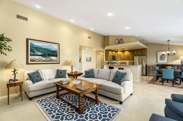 tiled living room featuring a notable chandelier and high vaulted ceiling