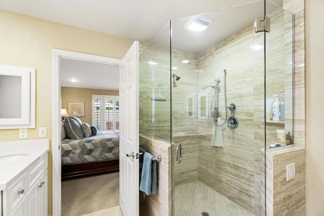 bathroom featuring a shower with door and vanity