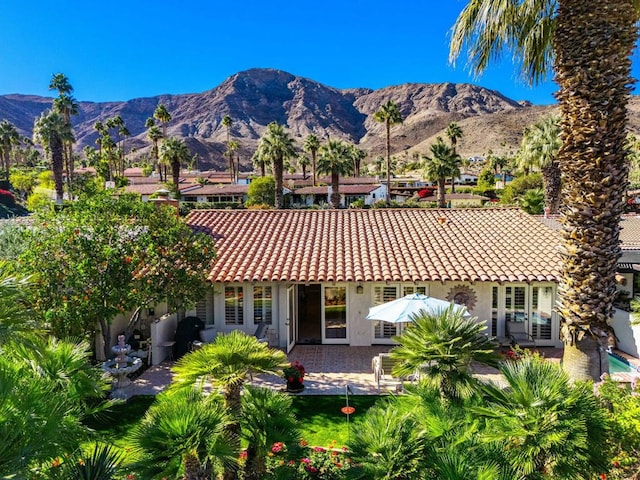 rear view of house featuring a patio and a mountain view