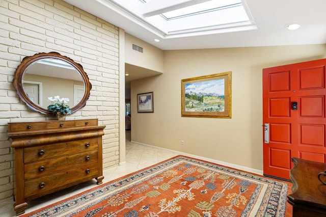 tiled foyer featuring lofted ceiling