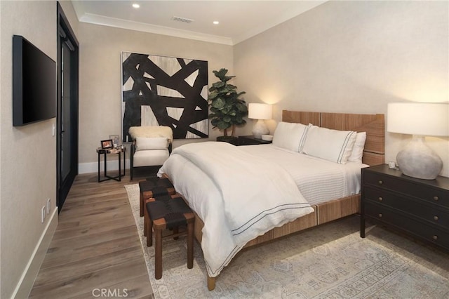 bedroom featuring hardwood / wood-style flooring and ornamental molding