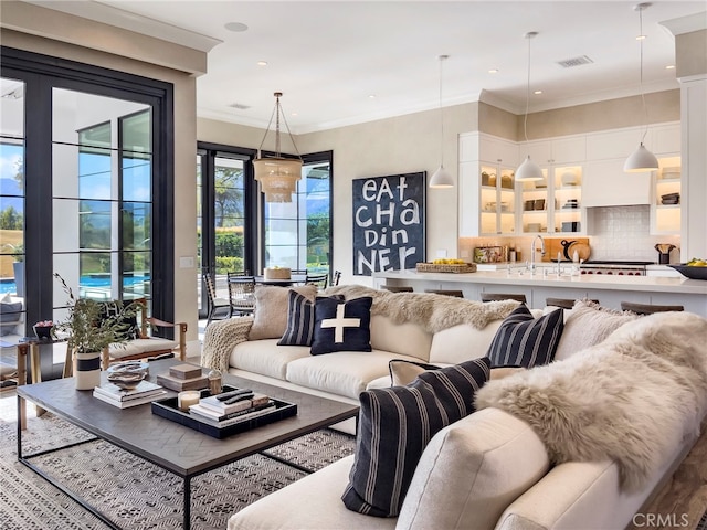 living room featuring crown molding and sink