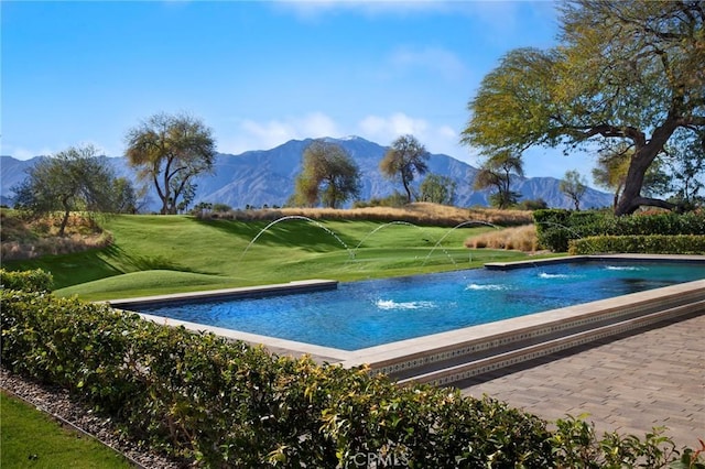 view of swimming pool featuring a mountain view