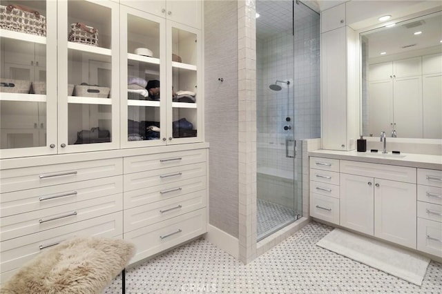 bathroom with an enclosed shower and vanity